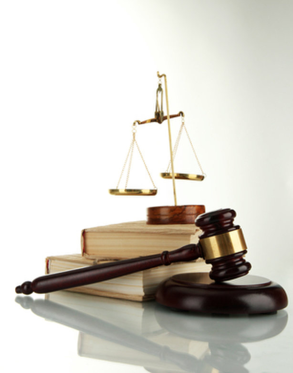 Golden scales of justice, gavel and books isolated on white
